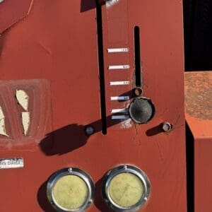 IMG_1336 - Montana Auctions by Kevin Hill Close-up of a red industrial control panel with vertical gauge slider and two circular yellow meters (readouts) at the bottom.