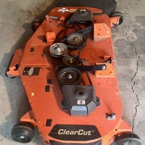 Orange ClearCut mower deck with belts and pulleys on a concrete floor.