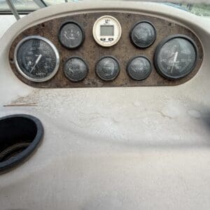 IMG_6556 - Montana Auctions by Kevin Hill Old, rusted boat cockpit gauge panel with multiple round gauges and a small central display.