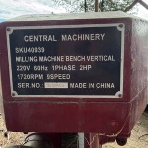 IMG_6572 - Montana Auctions by Kevin Hill Close-up of a red milling machine housing with a blue nameplate listing Central Machinery SKU40939 and specs (vertical bench mill).