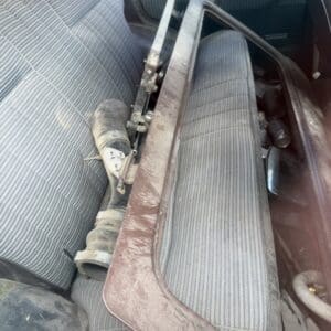 IMG_6592 - Montana Auctions by Kevin Hill Dusty car interior with a detached brown center console panel resting on the front seat.