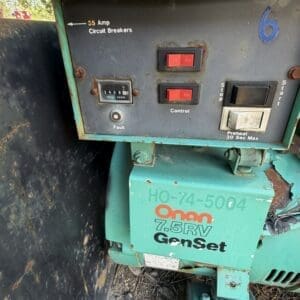IMG_6668 - Montana Auctions by Kevin Hill Weathered teal generator control panel with red On/Off switches, a 'Fault' indicator light, and a 'Preheat 30 Sec Max' label above the base; green GenSet unit outdoors.