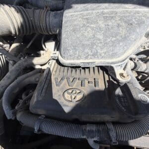 IMG_6683 - Montana Auctions by Kevin Hill Close-up of a dusty Toyota VVT-i engine cover in the engine bay.