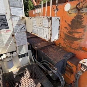 IMG_6719 - Montana Auctions by Kevin Hill Close-up of rusty construction equipment controls with levers and hydraulic hoses.