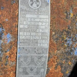 IMG_6752 - Montana Auctions by Kevin Hill Weathered metal nameplate reading 'Fairbanks Morse' induction motor specifications on a rusted surface, with frame SK224 and wiring diagram visible. Close-up of a vintage Fairbanks Morse motor data plate attached to corroded metal, showing wiring diagrams and voltage/amp details. Information plaque on old equipment listing motor type, frame number, horsepower, voltage, amps, and service factor amid rust. Functional/description: A data plate for an induction motor, including model details and wiring diagram (used on machinery). Rusty nameplate for a Fairbanks Morse induction motor with wiring diagram and technical specs.