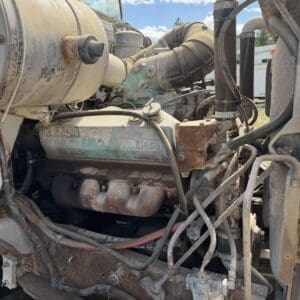 IMG_6907 - Montana Auctions by Kevin Hill Rusty diesel engine of a heavy truck with exposed hoses and pipes under a blue sky